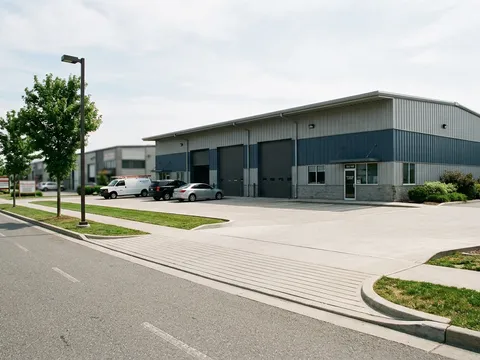 Pre-engineered steel industrial building in a business park with concrete approach