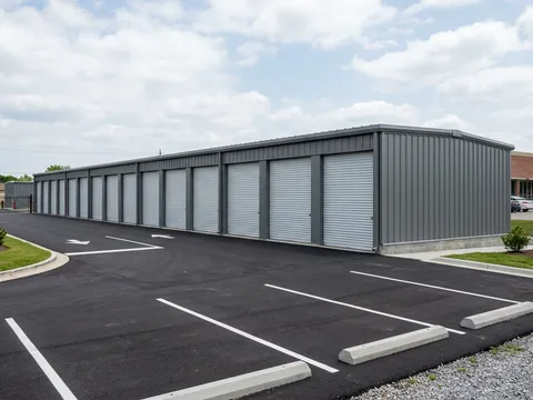 Row of steel storage units in a commercial strip mall setting